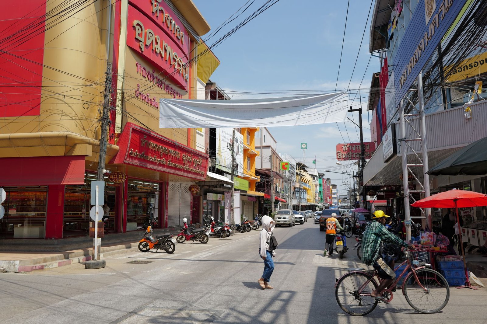 Lively urban street in Thailand with people, shops, and traffic under a sunny sky. — How to Choose the Best Volunteer Program